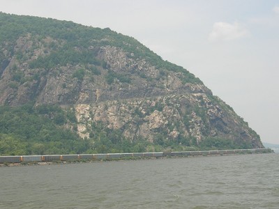 Train passes at the foot of Storm King