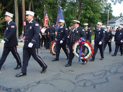 The fire departments entered before they laid wreaths at the 9-11 memorial bench.