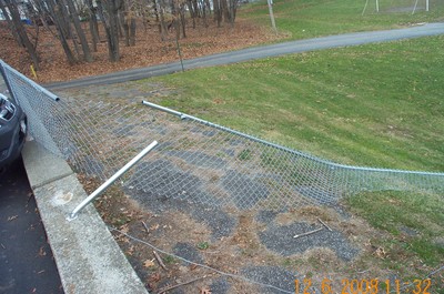 The car went through this fence and down the hill.