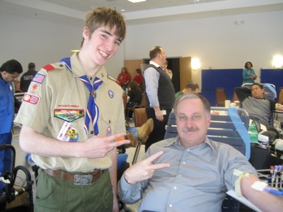 Orange County Sheriff Carl DuBois with Ian.  There fingers reflect the two times DuBois has helped out the blood drive.