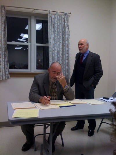 Peter Neuman takes notes while Mayor Gross responds to a question at Friday's debate.  Photo by Julia Lawrence.