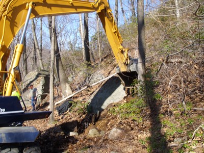 The crew dug out the remaining half of the boulder from Black Rock Forest.