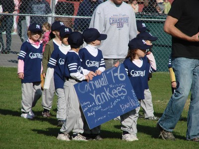 The t-ball players were at the front of the  parade.
