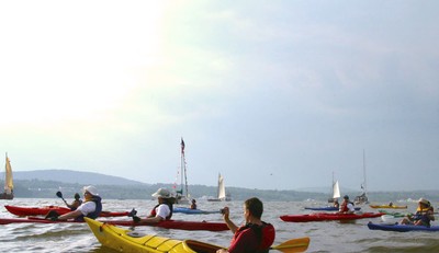 The kayakers amid the flotilla of ships.