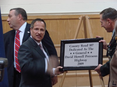 Orange County Executive Ed Diana unveils the new sign.