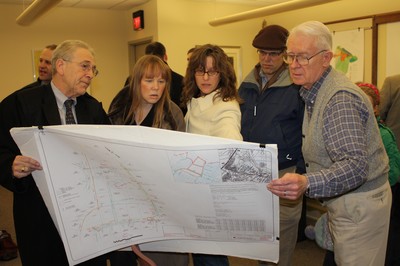 Karen Eremin (center) and other neighbors of the planned sub-division listened as Gerald Zimmerman described the proposed development.