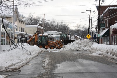 A highway department crew removes snow on Main Street.