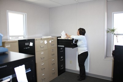 DPW secretary Arlene Roberts works in the records room in the trailer.
