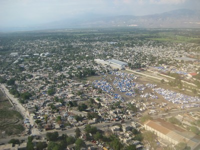 A view of the blue tarps where people are find shelter.