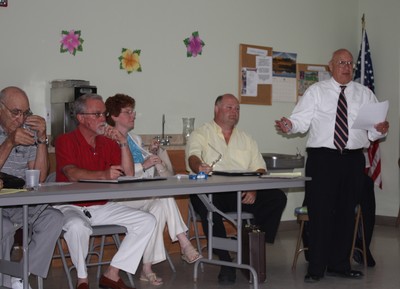 Town attorney Jim Loeb explains his legal opinion on the proposed purpose of NYMA while the town council members listen.