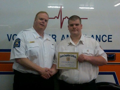 Captain Jack Boyle congratulates his son, Sean, after he received his EMT certificate.