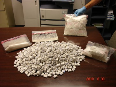 Police seized two kilos of heroin, some of which is seen here. Shown here are one thousand decks of heroine (each deck has 10 sleeves) and a bundle of heroine that has been ?sleeved? but not ?decked?