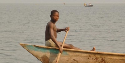 A young boy works on a fishing boat on Lake Volta.