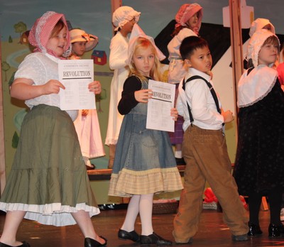 The colonists sing and dance to show their displeasure with England.