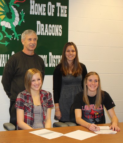Rachel Miller (l) and Kim Sharo, with their soccer coaches, Rick Miller and Amanda Greenblatt, standing behind them. 