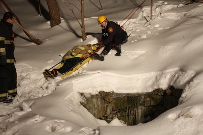 Rescue workers moved the injured hiker down the icy slope.