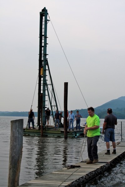 Yacht club members use the pile driver to secure the dock. Photo by Karen Schaack.