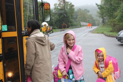 Katarina and Genevieve Daly say goodbye to their mother before boarding the bus.