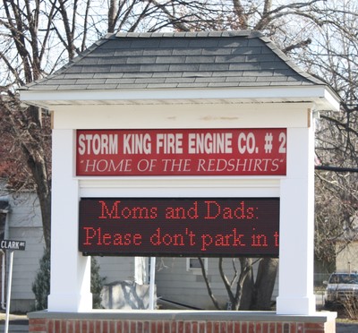 The sign outside the firehouse reminds parents not to park in firefighters' spots.