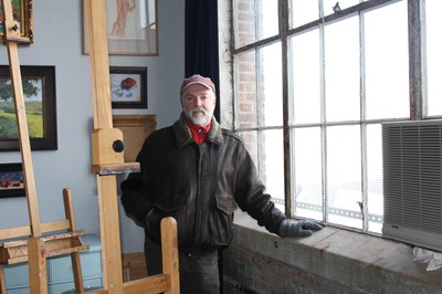 Andrew Lattimore inside his art classroom at Firth Carpet Monday morning as smoke swirled outside the window.