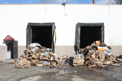 Some of the debris remained outside the packing company's loading dock after the fire this week.