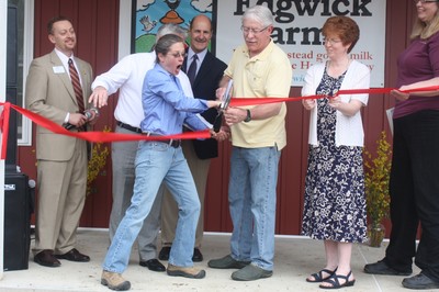 Talitha Thurau has fun cutting the ribbon.