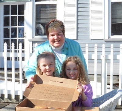 Photo by Jim Lennon. Karen Kaiser Sharp helps Madison and Kylie sell candy.