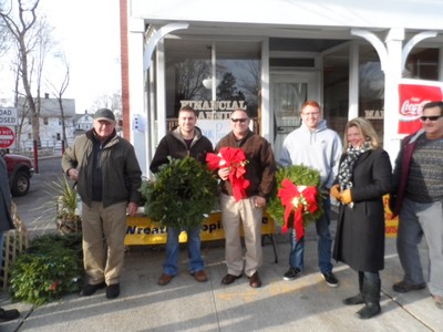 Photo by Jim Lennon. Cornwall Lions Club members Ed Moulton(left) along with Monique Summerfield and Bill Rubnitz (right) are pictured with three customers who had just purchased holiday wreaths at the Cornwall Lions Annual Holiday Sale on Main Street in Cornwall.