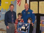 Principal Schmidt with the astronaut and Nicky and Georgie Poindexter