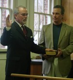 Quigley takes the oath of office as John Katonah holds a bible