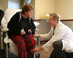 Physical therapist Jon Jonasch works with Linda Lockrow after her surgery.