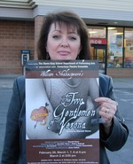 Anne Fulton with posters promoting the performances.