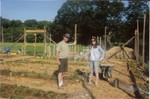 Art Williams and Virginia Gordon with wire cages for tomato plants.