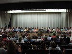 The fourth-graders listened on stage...