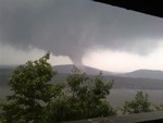 The funnel clouds of a twister that touched down in Newburgh.