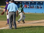 Justin Hines rounds third base on his way home in the first game of the Major boys.