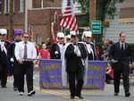 The Grand Knights of the Knights of Columbus lead the way.