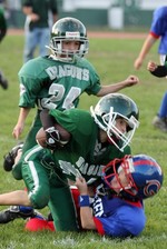 Cornwall player gets tackled by a player from Goshen.