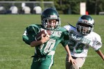 A Mighty Mite player runs with the ball.