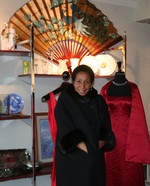 A shopper models one of the beautiful coats available for sale at the Auxiliary?s New to You Boutique.