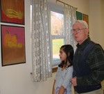 Bob Rosenberg admires a drawing with a student.