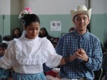 Couple dressed in western-style wear danced in a circle.