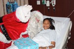 Santa visits a young patient on SLCH?s Pediatric unit compliments of the Greater Southern Dutchess Chamber of Commerce?s ?Hub? group for young professionals.