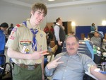 Orange County Sheriff Carl DuBois with Ian.  There fingers reflect the two times DuBois has helped out the blood drive.