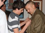Master Sgt. Kurpeawski's son pins the Bronze Star on his father.