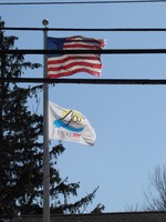 The Explore NY 400 Quadricentennial flag is flying outside village hall.