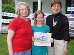 Grace Beil holds her winning artwork while Mary Ann G. Neuman (l) and Gail Parrinello look on.