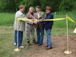 Rev. Bill Shillady, Gary Haugland, Steve Rosenberg and Mayor Joe Gross cut the ribbon at the new trailhead.