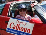 State representative Nancy Calhoun in a red convertible.