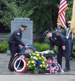 Police chiefs Todd Hazard and Charles Williams lay wreaths at the memorial bench.